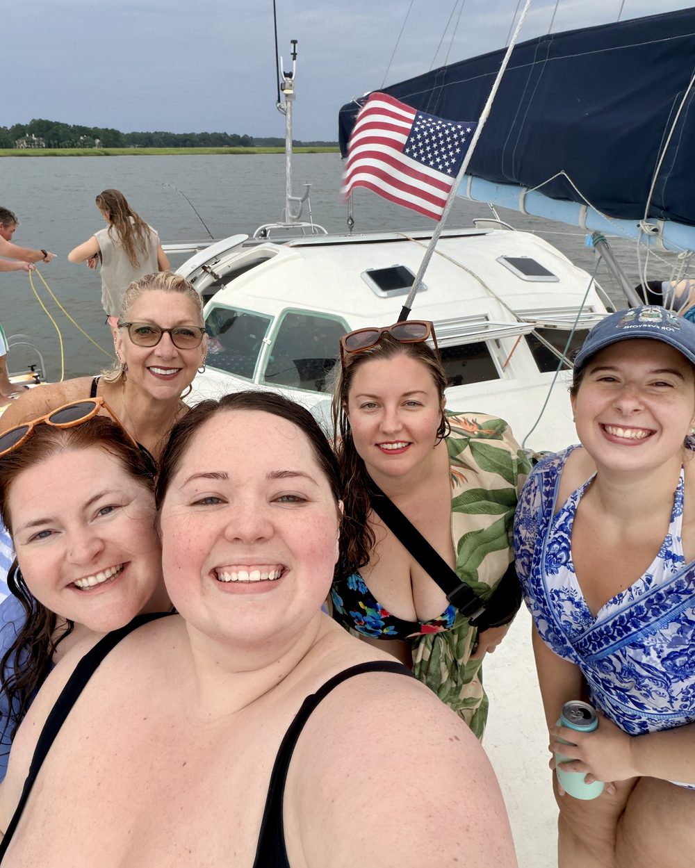 In Great Company members laughing together on a sailboat in Savannah